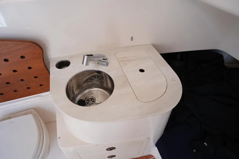Slide: The Image of 2024 Grady-White Canyon 336 boat interior with compact sink and faucet setup. - 37