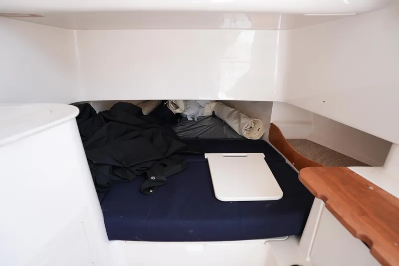 Slide: The Image of 2024 Grady-White Canyon 336 cabin interior with bed and storage space. - 38