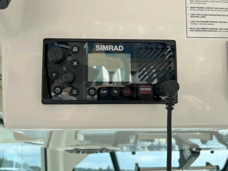 Slide: The Image of Simrad marine radio on 2025 Boston Whaler 360 Outrage boat dashboard. - 12