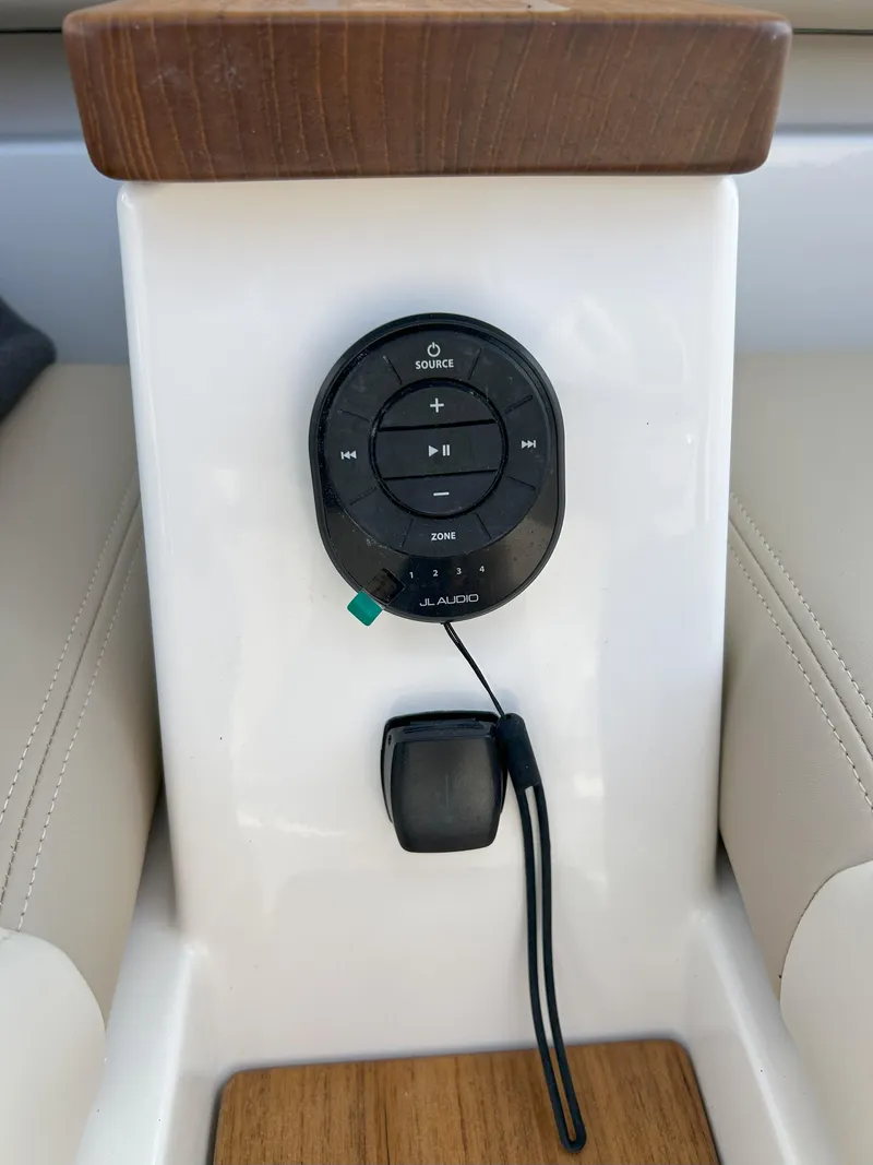 Slide: The Image of 2025 Boston Whaler 360 Outrage JL Audio control panel with sleek design and wood accents. - 21