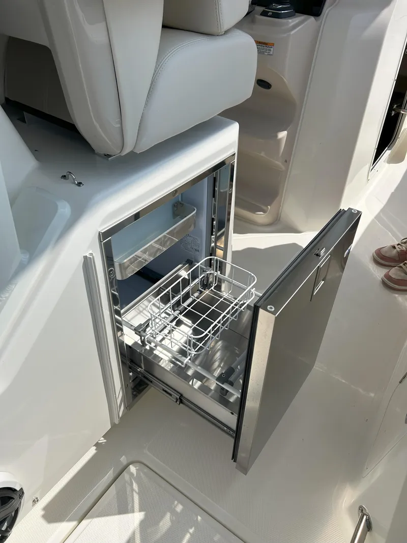 Slide: The Image of Open drawer on 2025 Boston Whaler 360 Outrage boat, showcasing storage compartment. - 25
