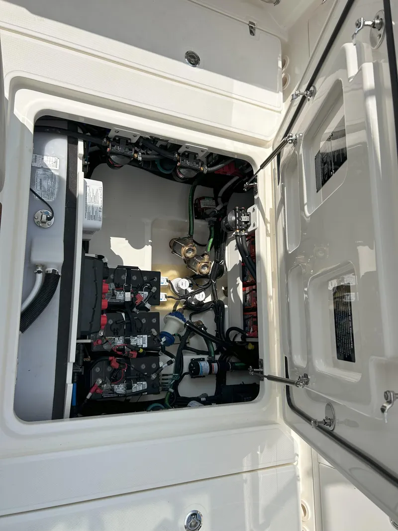 Slide: The Image of 2025 Boston Whaler 360 Outrage engine compartment with wiring and components. - 26