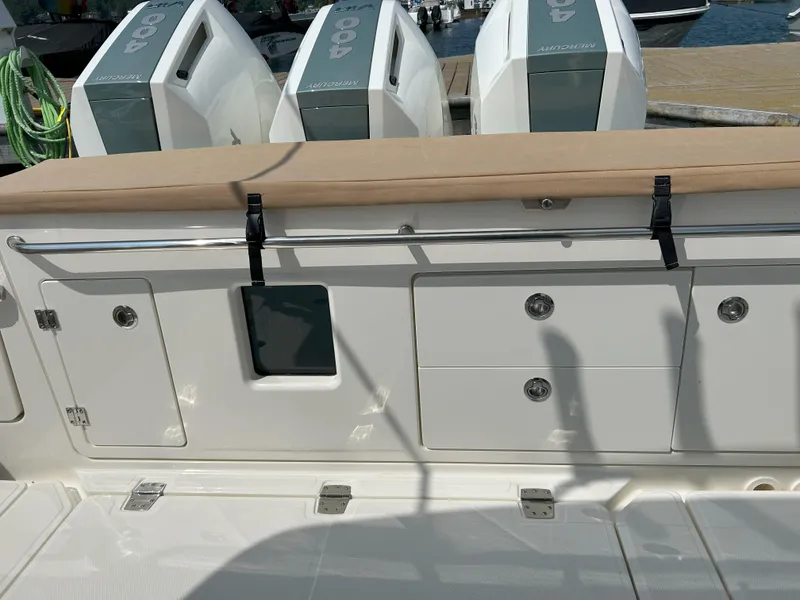 Slide: The Image of 2025 Boston Whaler 360 Outrage boat with triple Mercury 400 engines at dock. - 27