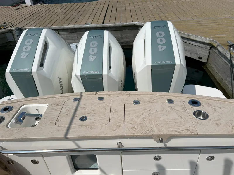 Slide: The Image of 2025 Boston Whaler 360 Outrage with triple Mercury 400 engines at dock. - 32