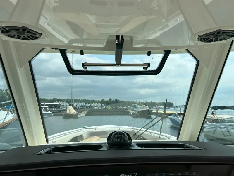 Slide: The Image of Interior view from a 2025 Boston Whaler 360 Outrage, overlooking a marina. - 9