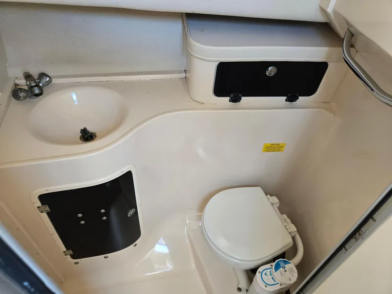 Slide: The Image of 2003 Grady-White Marlin 300 boat bathroom with sink, toilet, and storage compartments. - 10