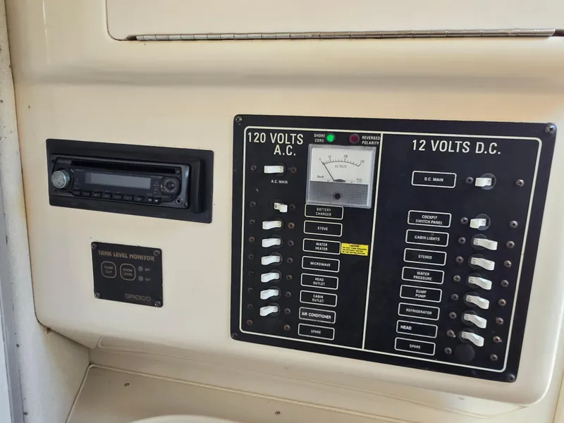 Slide: The Image of Electrical control panel on a 2003 Grady-White Marlin 300 boat, featuring AC and DC switches. - 11