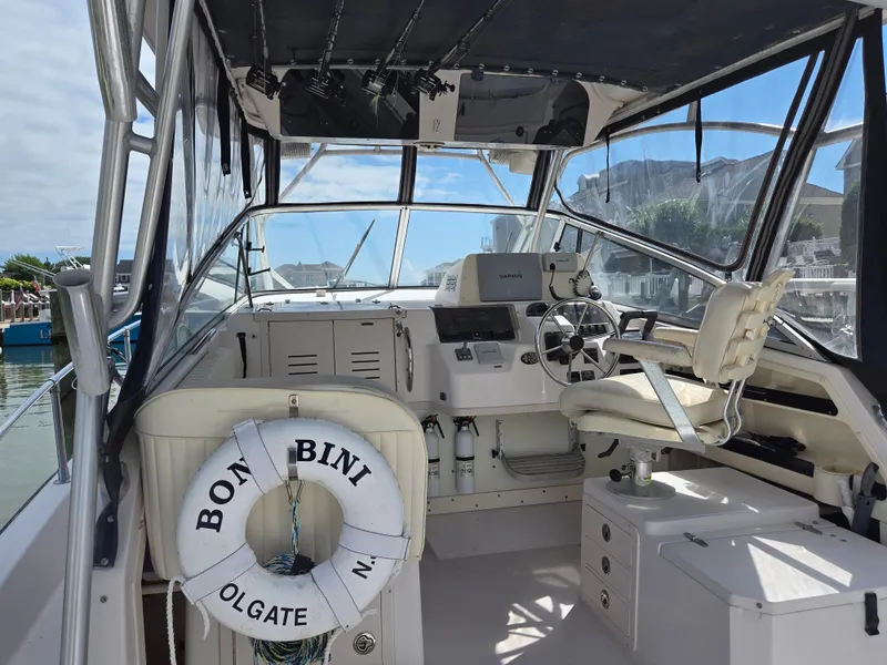 Slide: The Image of 2003 Grady-White Marlin 300 boat cockpit with steering wheel and life preserver. - 19