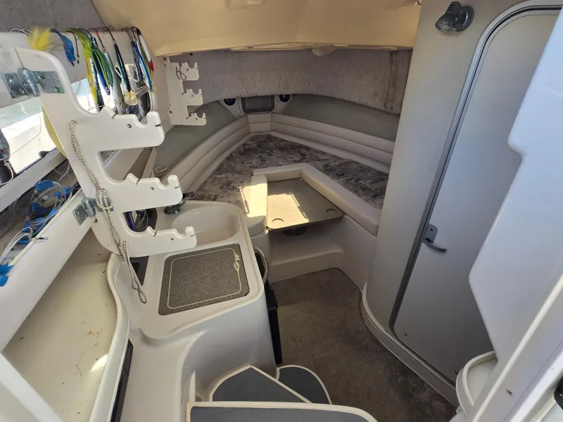 Slide: The Image of 2003 Grady-White Marlin 300 cabin interior with fishing gear and seating area. - 2