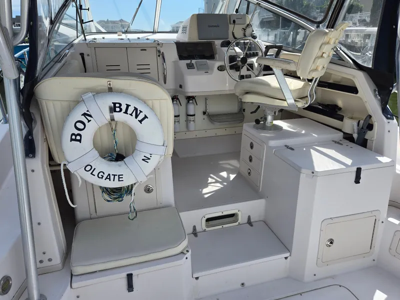 Slide: The Image of 2003 Grady-White Marlin 300 boat interior with steering wheel and life preserver. - 20