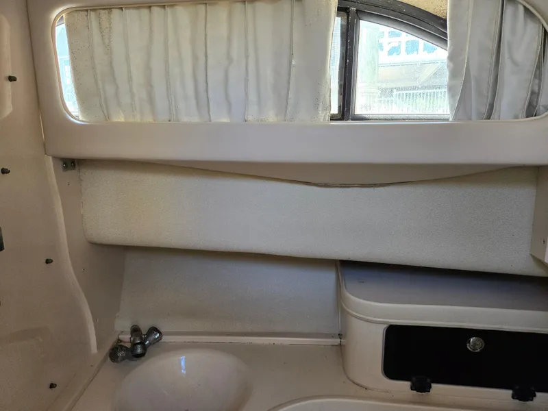 Slide: The Image of 2003 Grady-White Marlin 300 cabin interior with sink and window. - 26