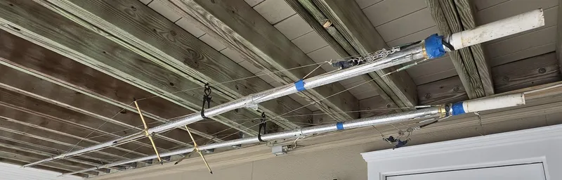 Slide: The Image of Ceiling-mounted fishing rod holders on a wooden deck, Grady-White Marlin 300, 2003 model. - 27