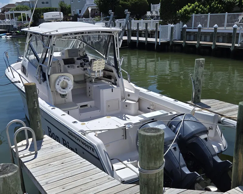 Slide: The Image of 2003 Grady-White Marlin 300 boat docked at marina with twin Yamaha engines. - 4