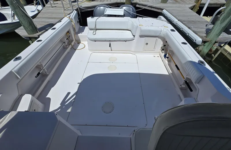 Slide: The Image of 2003 Grady-White Marlin 300 boat deck with seating and storage, docked at marina. - 5