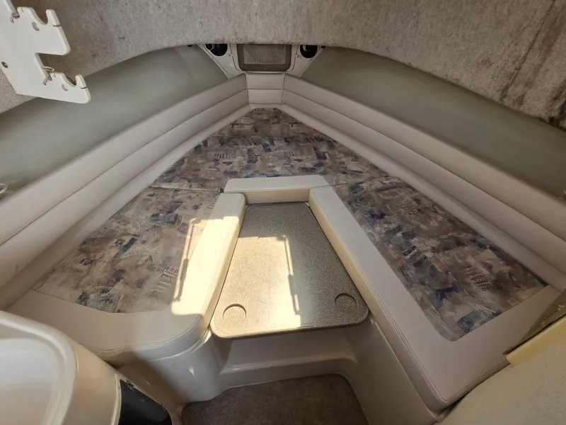 Slide: The Image of 2003 Grady-White Marlin 300 cabin interior with cushioned seating and table. - 6