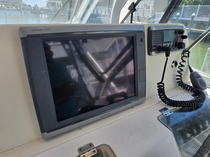 Slide: The Image of 2003 Grady-White Marlin 300 boat dashboard with Garmin GPSmap 7212 and VHF radio. - 8
