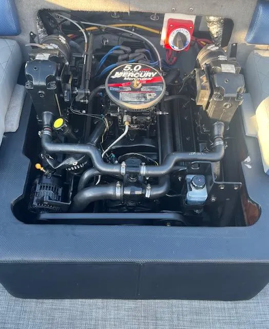 Slide: The Image of 2006 Bayliner 215 Classic boat engine, featuring a 5.0 Mercury motor. - 5