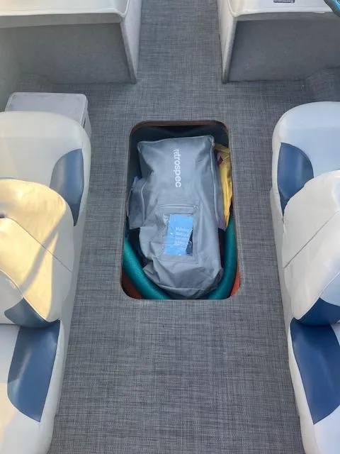 Slide: The Image of 2006 Bayliner 215 Classic boat interior with storage compartment open, revealing equipment. - 7