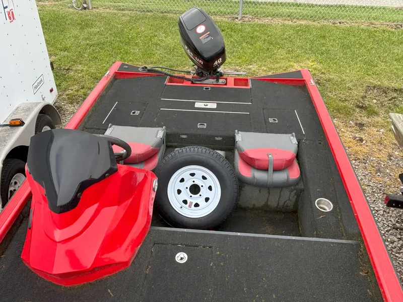 Slide: The Image of Red 2020 Raptor 160 Bass boat with motor and spare tire on deck. - 7
