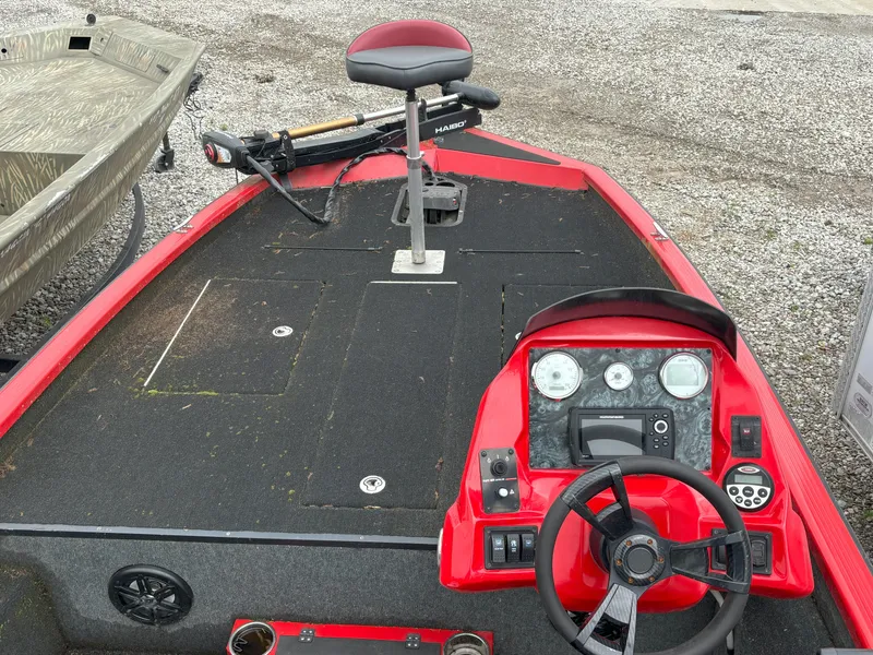 Slide: The Image of Red 2020 Raptor 160 Bass boat interior with steering wheel and control panel. - 8
