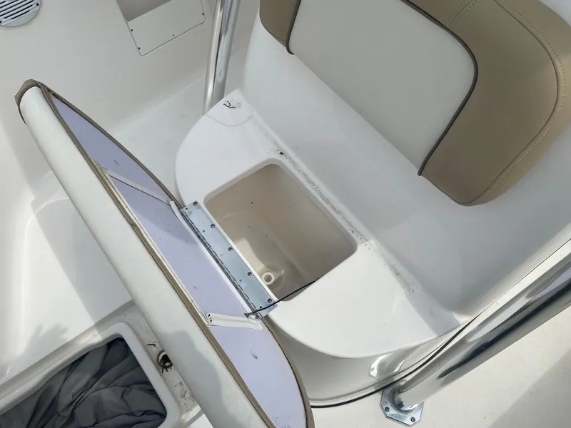 Slide: The Image of Open storage compartment on 2019 Key West 239 FS boat, featuring cushioned seating. - 12