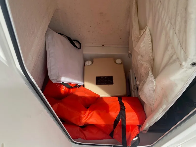 Slide: The Image of Storage compartment in 2019 Key West 239 FS boat with life jackets and equipment. - 14