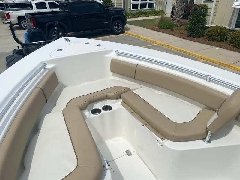 Slide: The Image of 2019 Key West 239 FS boat interior with beige seating and cup holders. - 17