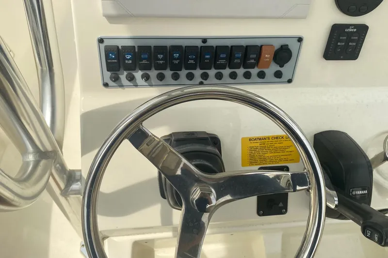 Slide: The Image of Steering wheel and control panel of 2019 Key West 239 FS boat. - 18