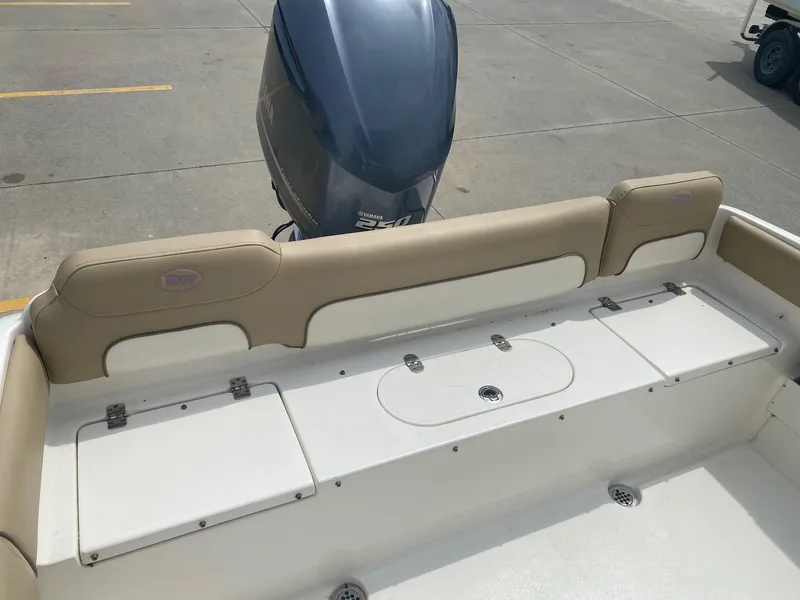 Slide: The Image of 2019 Key West 239 FS boat with Yamaha outboard motor, beige seating, and storage compartments. - 22