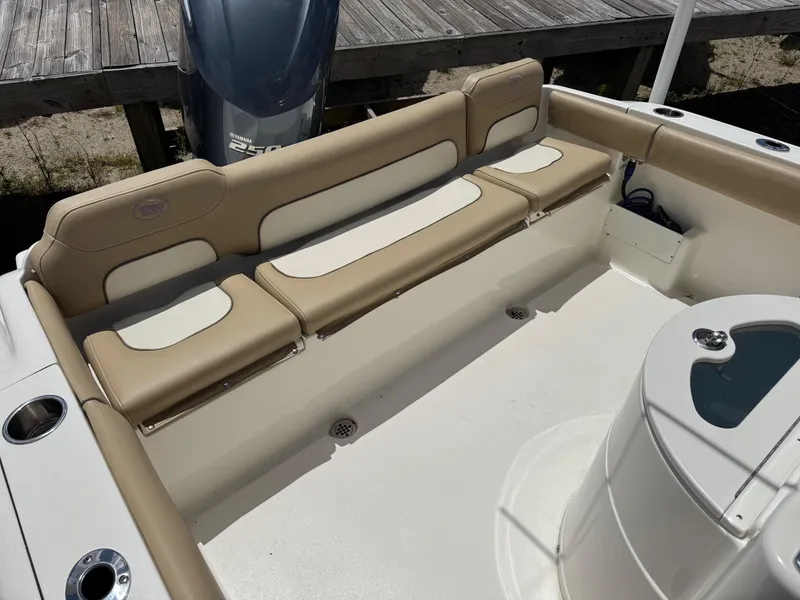 Slide: The Image of 2019 Key West 239 FS boat interior with tan seating and Yamaha engine. - 23