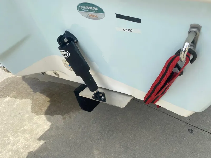 Slide: The Image of 2019 Key West 239 FS boat transom with trim tab and red strap. - 4