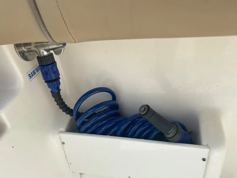 Slide: The Image of Blue coiled hose in a 2019 Key West 239 FS boat's raw water washdown system. - 5