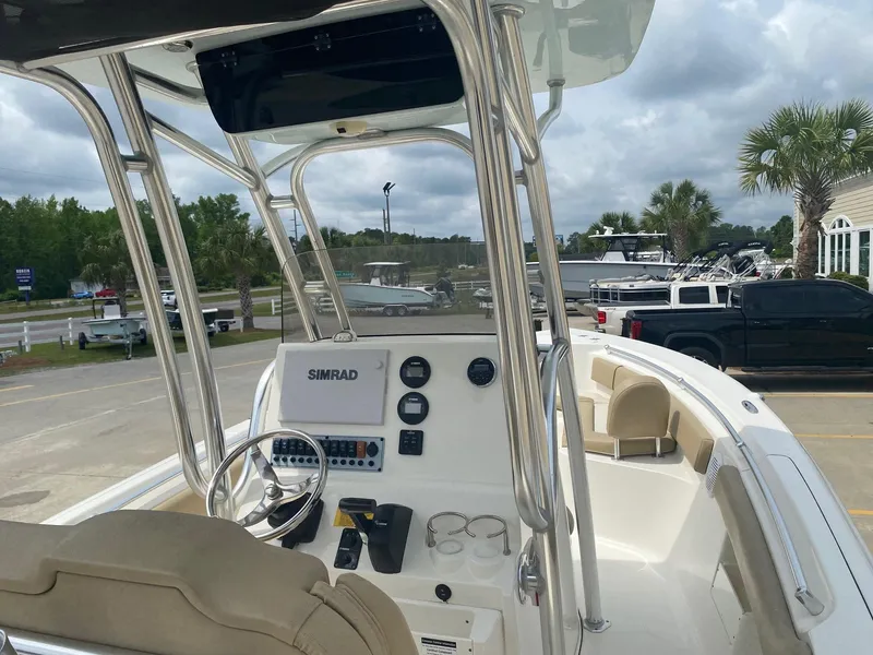 Slide: The Image of 2019 Key West 239 FS boat interior with steering console and Simrad display. - 7