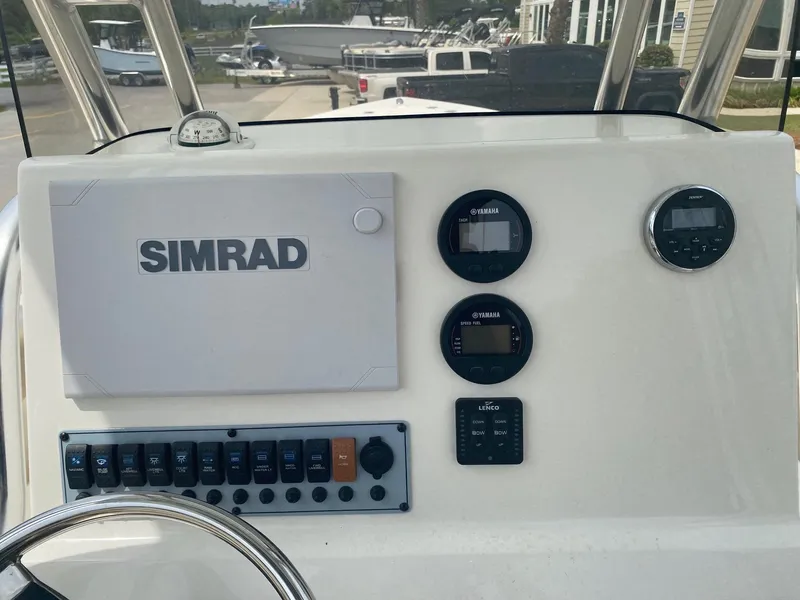 Slide: The Image of 2019 Key West 239 FS boat dashboard with Simrad display and Yamaha gauges. - 8