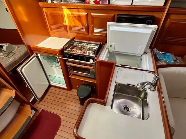 Slide: The Image of Interior of 2007 Beneteau 373 sailboat kitchen with stove, fridge, and sink. - 14