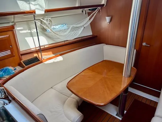 Slide: The Image of Interior of 2007 Beneteau 373 sailboat with wooden table and cushioned seating. - 15