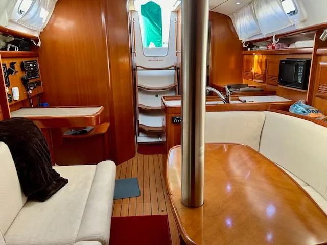 Slide: The Image of Interior of 2007 Beneteau 373 sailboat with wood finish and cozy seating area. - 16