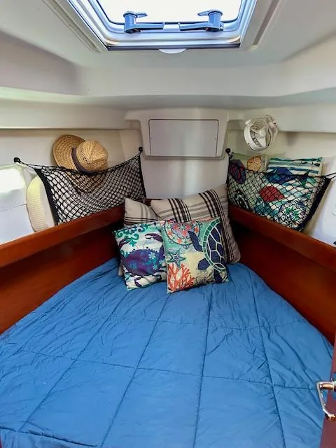 Slide: The Image of Cozy cabin interior of 2007 Beneteau 373 sailboat with colorful pillows and skylight. - 19