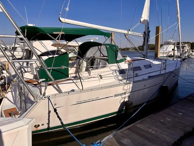 Slide: The Image of 2007 Beneteau 373 sailboat docked, featuring green canopy and white hull. - 2