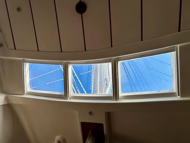 Slide: The Image of Interior view from a 2007 Beneteau 373 sailboat, showcasing windows and mast. - 21