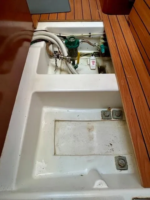 Slide: The Image of Beneteau 373 (2007) sailboat interior with open engine compartment and wooden flooring. - 22