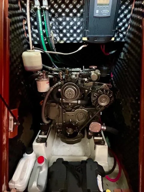 Slide: The Image of Engine compartment of a 2007 Beneteau 373 sailboat, featuring mechanical components and wiring. - 24