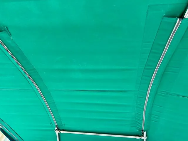 Slide: The Image of Green canopy of a 2007 Beneteau 373 sailboat, featuring metal support frames. - 28