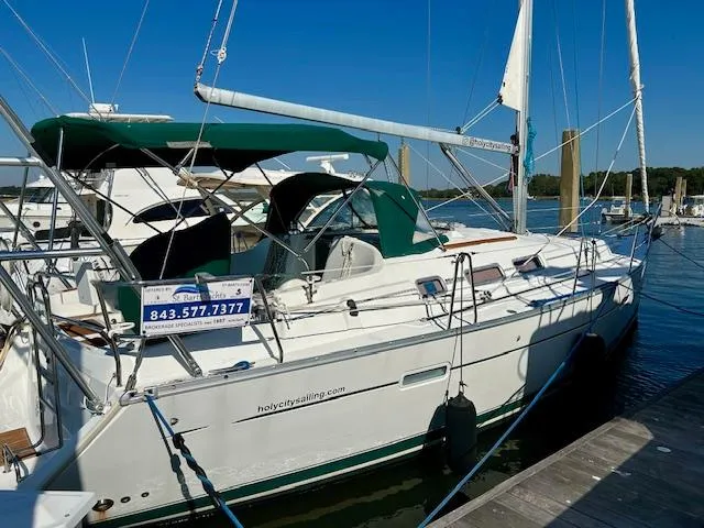 Slide: The Image of 2007 Beneteau 373 sailboat docked, featuring green canopy and white hull. - 35