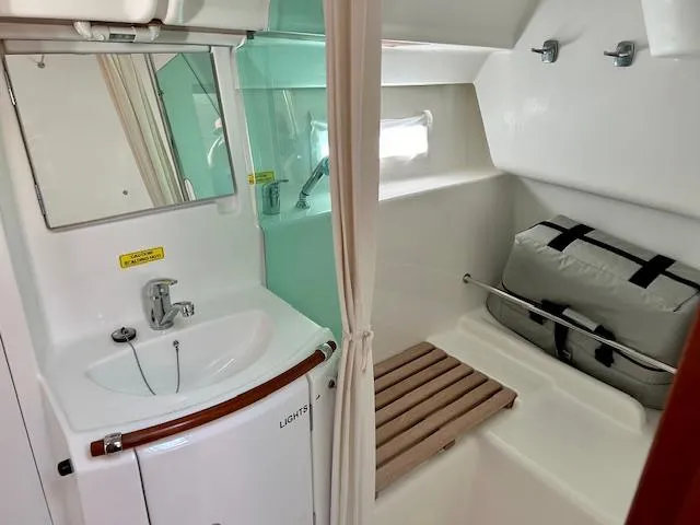 Slide: The Image of 2007 Beneteau 373 yacht bathroom with sink, mirror, and storage area. - 9