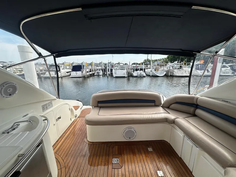Slide: The Image of 2001 Sunseeker Camargue 44 yacht interior with wooden deck and marina view. - 13