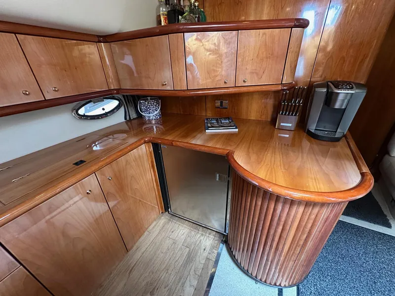 Slide: The Image of Luxurious wooden interior of 2001 Sunseeker Camargue 44 yacht with kitchenette and appliances. - 16