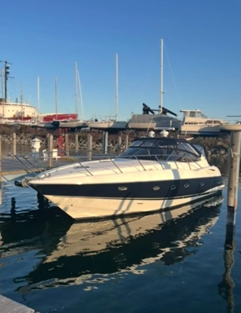 Slide: The Image of 2001 Sunseeker Camargue 44 yacht docked in marina under clear blue sky. - 2