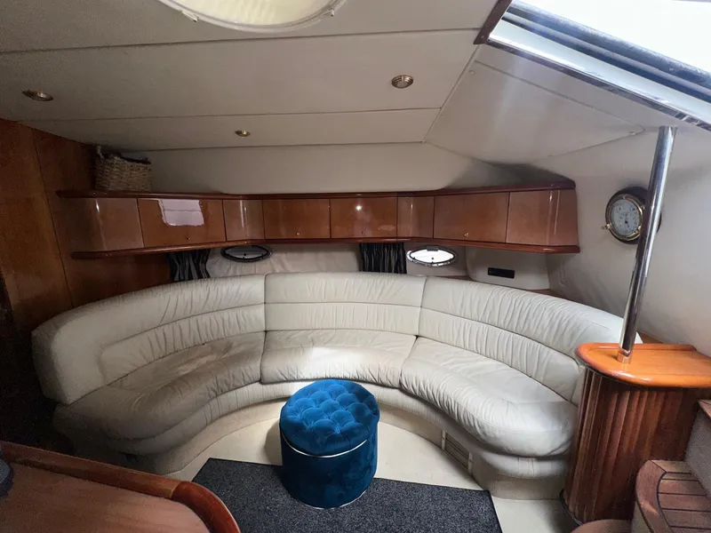 Slide: The Image of Interior of 2001 Sunseeker Camargue 44 yacht with white leather seating and blue ottoman. - 29