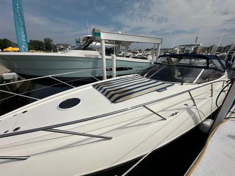 Slide: The Image of 2001 Sunseeker Camargue 44 yacht docked at marina under clear sky. - 3